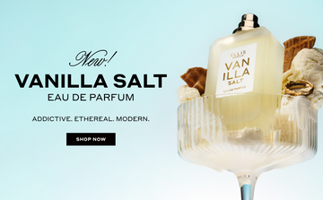 Vanilla Salt 50ml Eau De Parfum without cap in glass with vanilla ice cream, pieces of ice cream cone, and gold ring, on light blue background, next to black text that reads