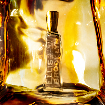 Blond Musk Fragrance Oil 15ml behind block of amber.