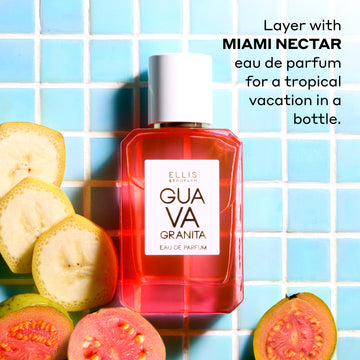 Guava Granita 50ml Eau De Parfum on light blue tile next to sliced banana and guava with black text that reads "Layer with Miami Nectar Eau De Parfum for a tropical vacation in a bottle."