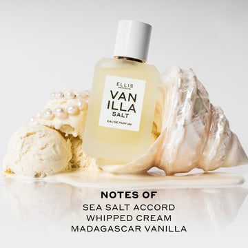 Vanilla Salt 50ml Eau De Parfum resting on white shell in melted vanilla ice cream next to scoops of vanilla ice cream and pearls on white background above black text that reads "Notes Of Sea Salt Accord, Whipped Cream, Madagascar Vanilla".