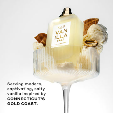 Vanilla Salt 50ml Eau De Parfum without cap in glass with vanilla ice cream, pieces of ice cream cone, and gold ring, on white background, above black text that reads "Serving modern, captivating, salty vanilla inspired by Connecticut's Gold Coast."