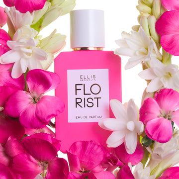 Florist Eau De Parfum 50ml on white background surrounded by pink and white flowers.