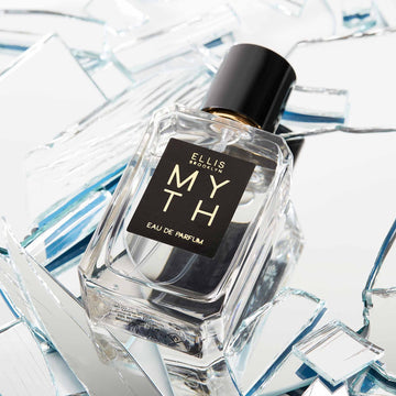 Myth 50ml bottle laying on mirrored pieces of glass.