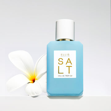 Blue Salt 50ml bottle with white flower on grey background.
