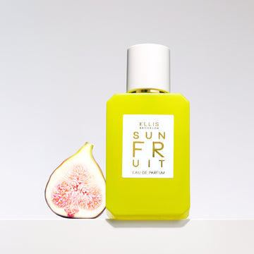 Sun Fruit 50ml bottle with sliced fig on grey background.