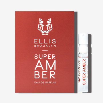 Super Amber 1.5ml Eau De Parfum Vial next to brick red Super Amber Eau De Parfum vial holder card.