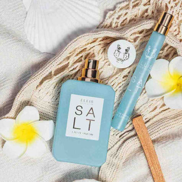 Salt 50ml and Salt 10ml on a net bag with white flowers and a sea shell.