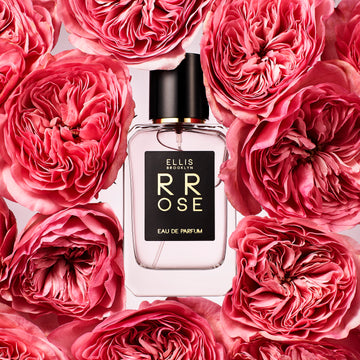 Rrose 50ml Eau De Parfum on light pink background surrounded by pink flowers.