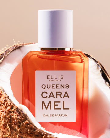 Queens Caramel 50ml Eau De Parfum in cut open coconut on beige background