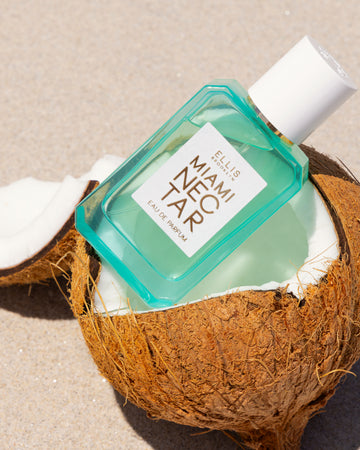 MIAMI NECTAR Eau de Parfum 50ml sits in coconut on tan sand