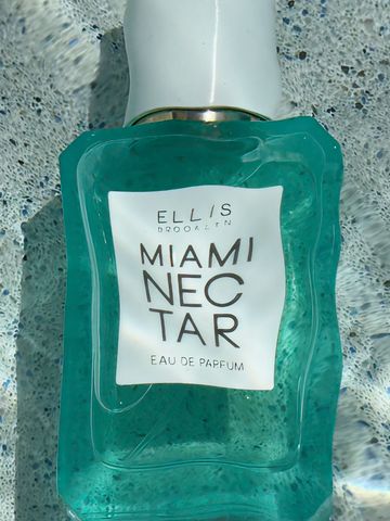 MIAMI NECTAR Eau de Parfum 50ml lays on gray stone underneath water