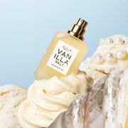 VANILLA SALT Eau de Parfum 7.5ml without cap behind silver shell on vanilla ice cream with pearls on top on a blue background