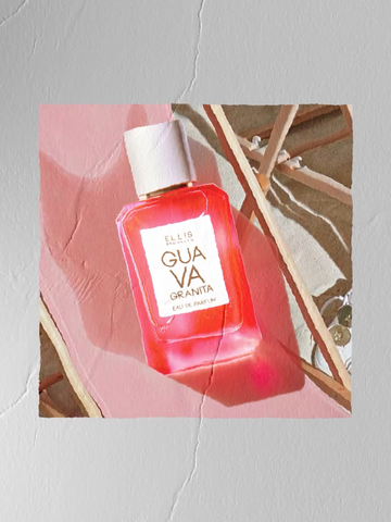 Painting of GUAVA GRANITA Eau de Parfum 50ml on a pink fabric and tan wood beach chair nex to a tan wooden table all on a gray cement surface 