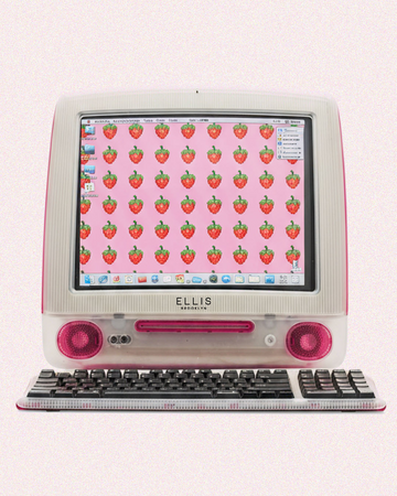 White and pink vintage computer and keyboard with black Ellis Brooklyn logo shows screen with pink background and red strawberries all on a pink background