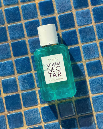 MIAMI NECTAR Eau de Parfum 50ml covered in water droplets against blue tiles