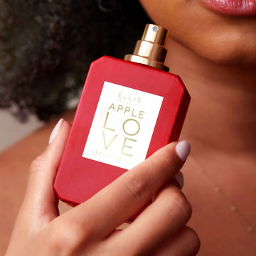 IMAGE 6: MODEL HOLDING APPLE LOVE NEAR FACE