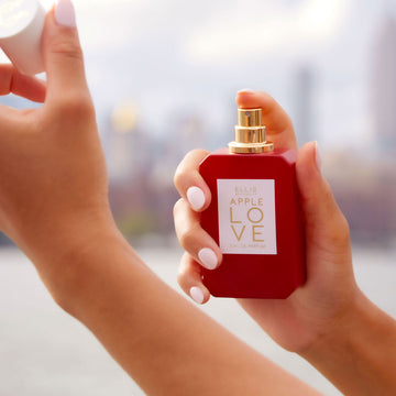 IMAGE 2: MODEL HOLDING AND SPRAYING APPLE LOVE