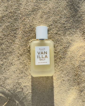 VANILLA SALT 50ml Eau de Parfum lays on tan sand