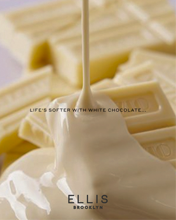 A close-up of white chocolate bars with melted white chocolate pouring over them. Small black text reads 'LIFE'S SOFTER WITH WHITE CHOCOLATE...' and a black Ellis Brooklyn logo. 