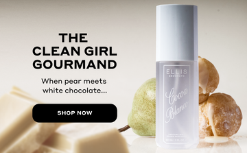 COCOA BLANCO Perfume Mist 90ml in front of pear and cream puffs and behind pile of white chocolate squares on gray background with black text that reads "The Clean Girl Gourmand. When pear meets white chocolate.." and a black circle and white text that reads "Shop Now"