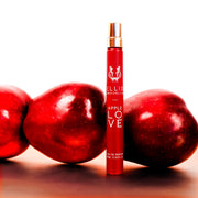 Spray de parfum de voyage Apple Love 10 ml sur une table blanche devant des pommes, sur un fond blanc.