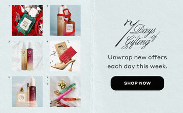 Blue banner with square images of Miami Nectar on silver foil and red bows, Queens Caramel, Marshmallows and Apple Love on blue background, Marshmallows and Vanilla Sin on white background, black text that reads "7 Days of Gifting. Unwrap new offers and exclusive deals each day", black oval with "Shop Now" in white text, Memoir and Mystery Gift Sets on high heel with falling diamonds, Vanilla Salt, Vanilla Milk, and Vanilla Sin circled with white lace and a bow, various travel sprays with gold bow.