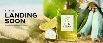 ISLA SIRENA Eau de Parfum 50ml without cap with sand on the bottle sits in sand next to it's cap, a slice of lime, a bunch of blue bananas, a green coconut, and a white flower with black text that reads "3.12.26. LANDING SOON. Breathtaking. Transportive. Joyful." and a blue sky in the background