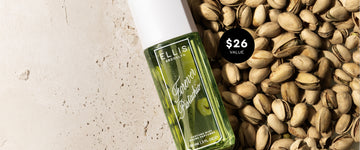 FOREVER PISTACHIO Perfume Mist 90ml on tan marble and pile of pistachios with black circle with white text that reads "$26 Value"
