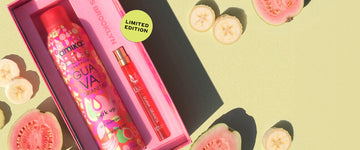 Amika x Ellis Brooklyn GUAVA GRANITA Perk Up Dry Shampoo and GUAVA GRANITA Eau de Parfum 10ml gift set next to sliced guavas and bananas on light green background with green circle with black text that reads "Limited edition"