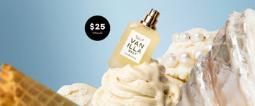 Mini Vanilla Salt eau de parfum 7.5mL bottle with a black circle that states "$25 VALUE" styled on top of vanilla bean ice cream swirls with pearl beads and a waffle piece against a light blue background. | english_image