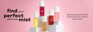 BANANA MILKSHAKE Perfume Mist 90ml, VANILLA SIN Perfume Mist 90ml, MARSHMALLOWS Perfume Mist 90ml, FIRST DATE Perfume Mist 90ml, MISS STRAWBERRY Perfume Mist 90ml sit on white pedestals at varying heights with black text that reads "Find your perfect perfume mist. Take the quiz and find the perfect perfume mist for every mood!" on pink background