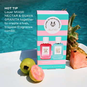 Beach Club Mini Fragrance Gift Set box on white table with whole guava, half guava, whole pineapple, and slice of pink pineapple with pool in background, and white text that reads  "Hot Tip Layer Miami Nectar and Guava Granita Together To Create A Lush Tropical Fragrance Combo."