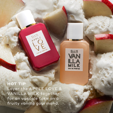 Apple Love 7.5ml Eau De Parfum Mini Dabber and Vanilla Milk 7.5ml Eau De Parfum Mini Dabber on sliced red apples and vanilla ice cream with white text that reads "Hot Tip Layer the Apple Love & Vanilla Milk together for an upscale take on a fruity vanilla gourmand."