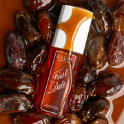 FIRST DATE Perfume Mist 90ml covered in a drizzle of date syrup lays on pile of dates and date syrup 