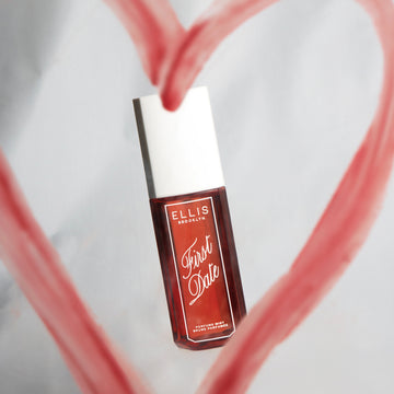 FIRST DATE Perfume Mist 90ml on gray background surrounded by a red heart drawn in lipstick