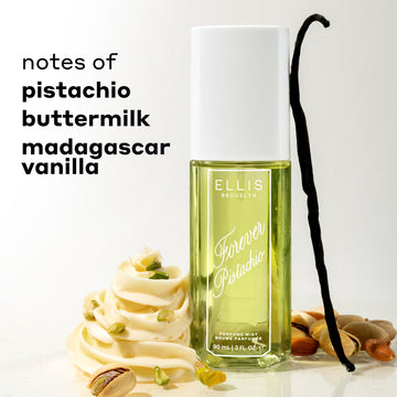 FOREVER PISTACHIO Perfume Mist 90ml between white icing, pistachios, and a vanilla bean against a white background with black text that reads "notes of pistachio, buttermilk, madagascar vanilla"