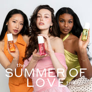 Woman with black hair wearing an orange dress and white pearl earrings holds NEW CRUSH Perfume Mist 90ml, woman with brown hair wearing a pink off the shoulder top and pink earrings holds LOVE POM Perfume Mist 90ml, and woman with brown hair wearing green tank top, gold bracelet and white and black polka dot skirt holds FOREVER PISTACHIO Perfume Mist 90ml on a white background with white text that reads "the SUMMER OF LOVE trio"