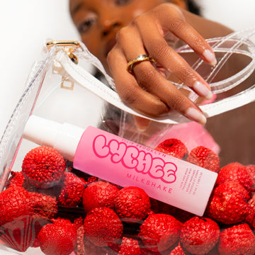 IMAGE 6: MODEL HOLDING BAG WITH LYCHEE MILKSAHKE 50ML INSIDE 