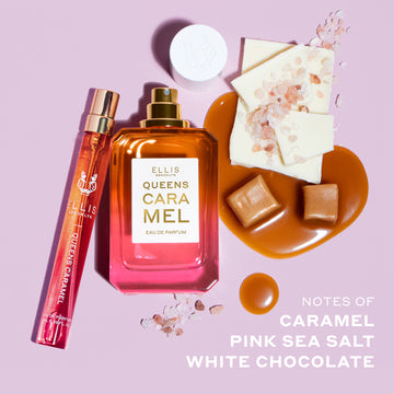 Queens Caramel 10ml Eau De Parfum Travel Spray next to Queens Caramel 50ml Eau De Parfum with cap removed, and melted caramel, caramel squares, pieces of white chocolate, and pink salt, above white text that reads "Notes of Caramel, Pink Sea Salt, White Chocolate" on light pink background.