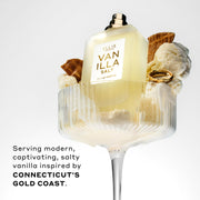 Vanilla Salt 50ml Eau De Parfum without cap in glass with vanilla ice cream, pieces of ice cream cone, and gold ring, on white background, above black text that reads 