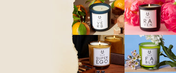 Collage image of Verb 6.5 oz. Terrific Scented Candle on beige background with oranges and blocks of wood, Raven 6.5 oz. Terrific Scented Candle on light pink background with pink flowers, Superego 6.5 oz. Terrific Scented Candle on wooden table next to game with dice and dice on table, in front of brown book, mirror, and black fabric, and Fable 6.5 oz Terrific Scented Candle on piece of wood with pink and white flowers, on blue background, next to torn white piece of paper.