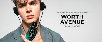Model with brown hair wearing gray jacket and headphones holding Worth Avenue 50ml Eau De Parfum to chin, on white background with black text that reads "For A Man Who Knows His Worth. Worth Avenue Eau De Parfum"