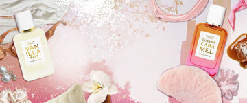 Vanilla Salt 50ml Eau De Parfum and Queens Caramel 50ml Eau de Parfum on pink background surrounded by pink headband, pink scarf, melted caramel, pink scrunchie, pink feather fan, white flower, white fur pillow, tan scrunchies, white pearl earrings, brown sunglasses, white sweater, salt , and leaves.