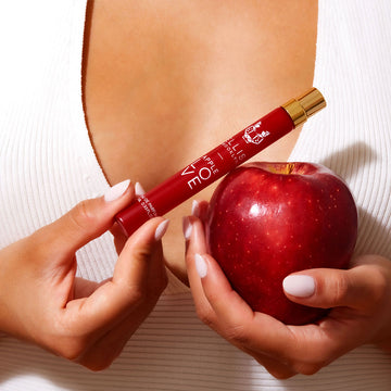 IAMGE 6: MODEL HOLDING APPLE LOVE TRAVEL SPRAY AND APPLE