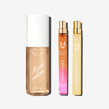 Bottle of Marshmallows Perfume mist next to a 10mL travel size of Queens caramel eau de parfum and a 10mL travel size bottle of Vanilla Salt set in front of a white background.
