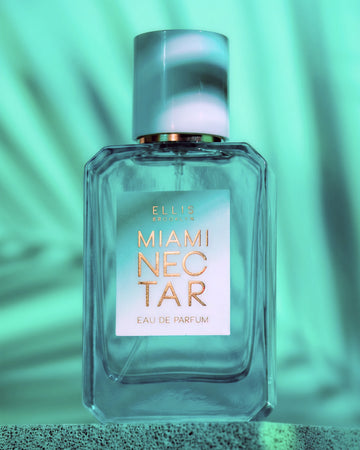 MIAMI NECTAR Eau de Parfum 50ml sits on concrete against a teal background covered by a shadow of a palm leaf
