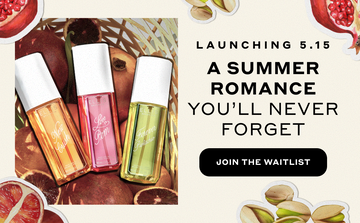 NEW CRUSH Perfume Mist 90ml, LOVE POM Perfume Mist 90ml, and FOREVER PISTACHIO Perfume Mist 90ml on top of basket filled with pomegranates on a light yellow background overlaid with images of drawn pistachios, sliced pomegranates, and sliced blood oranges outlined in white with black text that reads "A summer romance you'll never forget" and a black oval with white text that reads "Join the waitlist"