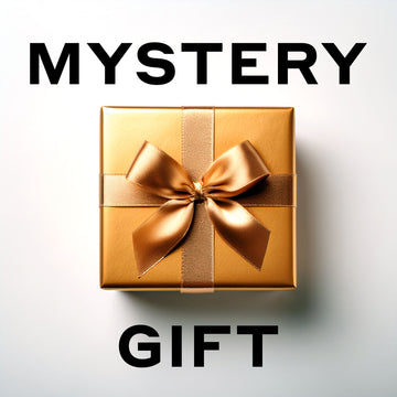 Gold gift box with bow on light gray background with black text that reads "Mystery Gift"