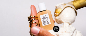 Model wearing gold rings holding vanilla ice cream and Vanilla Milk 7.5ml Eau De Parfum Mini Dabber in one hand next to gold ice cream scoop with vanilla ice cream, on white background with black circle with white text that reads "$25 value"