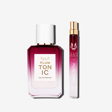 50mL bottle of Plum Tonic eau de parfum next to a 10mL travel size of Plum Tonic eau de parfum set in front of a white background.